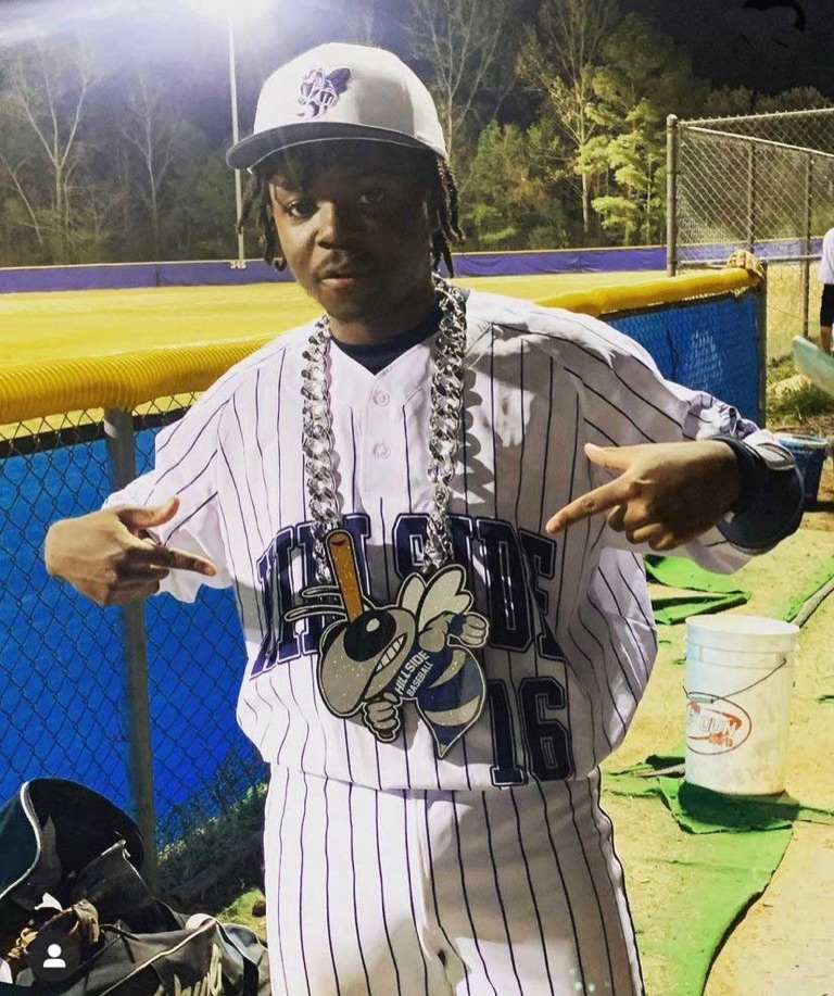 Baseball player in a Hornets uniform wearing a custom celebration chain