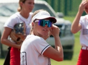 Girl wearing ThrillVision sports sunglasses, confidently positioned in the outfield.